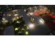 Night aerial view of complex with lighted tennis courts, pool, and landscaped grounds, highlighting the resort-style amenities at 2170 Robinhood St # C1-409, Sarasota, FL 34231