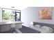 Bright bedroom features a modern desk area with a sleek design and large window view at 2170 Robinhood St # C1-409, Sarasota, FL 34231