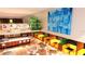Modern dining area with vibrant seating, open bar, and artwork, creating a chic social space at 2170 Robinhood St # C1-409, Sarasota, FL 34231
