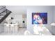 Modern living space with stairs features sleek kitchen, bar seating, and eye-catching abstract art at 2170 Robinhood St # C1-409, Sarasota, FL 34231
