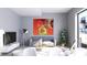 Inviting living room with neutral decor, flat screen tv, colorful wall art, and natural light at 2170 Robinhood St # C1-409, Sarasota, FL 34231