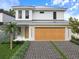 Modern two-story home features a stylish garage, sleek driveway, and well-maintained landscaping at 2483 Bay St, Sarasota, FL 34237