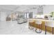 Open concept living area with modern kitchen island with bar seating and view into the living room at 2483 Bay St, Sarasota, FL 34237