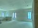 Large living room with many windows allowing for an abundance of natural light, ready to be customized at 2483 Bay St, Sarasota, FL 34237