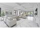 Bright and airy living room with comfortable seating, marble floors, and natural light at 2483 Bay St, Sarasota, FL 34237