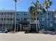Inviting condo building with a covered entrance, lush landscaping, and ample parking at 2700 Coconut Bay Ln # 432, Sarasota, FL 34237