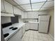 Efficient kitchen layout featuring white appliances and tile floors at 2700 Coconut Bay Ln # 432, Sarasota, FL 34237