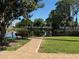 Scenic pond view with a bench, walkway, and lush greenery creating a tranquil atmosphere at 2700 Coconut Bay Ln # 432, Sarasota, FL 34237