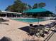 Relaxing pool area with lounge chairs and a table with an umbrella for a resort-like atmosphere at 2700 Coconut Bay Ln # 432, Sarasota, FL 34237
