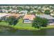 Aerial view of the home showing the pool, screened patio, lake and beautiful landscaping at 2931 Bravura Lake Dr, Sarasota, FL 34240