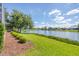 Lush landscaped backyard and serene lake view enhances the home's appeal at 2931 Bravura Lake Dr, Sarasota, FL 34240