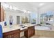 Bathroom featuring double sinks, a soaking tub, and plenty of natural light at 2931 Bravura Lake Dr, Sarasota, FL 34240