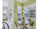 Inviting dining area with glass table and views of the lake at 2931 Bravura Lake Dr, Sarasota, FL 34240