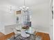 An airy dining room features a modern glass table set and matching decor at 2931 Bravura Lake Dr, Sarasota, FL 34240