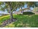 Lush landscaped backyard and screened-in patio showcases outdoor charm of the home at 2931 Bravura Lake Dr, Sarasota, FL 34240