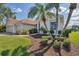 Lush landscaping adds curb appeal to this single Gathering home, with its terracotta roof and attached two car garage at 2931 Bravura Lake Dr, Sarasota, FL 34240
