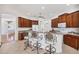 Cozy kitchen with a breakfast bar, wood cabinets, and stainless steel appliances at 2931 Bravura Lake Dr, Sarasota, FL 34240