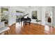 Bright living room with a piano and hardwood floors at 2931 Bravura Lake Dr, Sarasota, FL 34240
