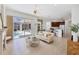 Open-concept living room flowing into the kitchen and dining areas with pool access at 2931 Bravura Lake Dr, Sarasota, FL 34240