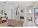 Cozy living room with a fireplace and views of the lake at 2931 Bravura Lake Dr, Sarasota, FL 34240