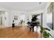 Spacious living room features hardwood floors, large windows and doors, and a black piano at 2931 Bravura Lake Dr, Sarasota, FL 34240