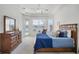 Main bedroom with lake view and door to the patio at 2931 Bravura Lake Dr, Sarasota, FL 34240