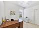 Bright office features a large wooden desk, a window and bright walls for productive work environment at 2931 Bravura Lake Dr, Sarasota, FL 34240