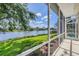 Screened patio overlooks tranquil waterfront view, lush landscaping, and outdoor living in a beautiful home at 2931 Bravura Lake Dr, Sarasota, FL 34240
