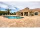 Inviting community pool with brick paver patio, surrounded by lush landscaping and mature palms, perfect for relaxation at 2931 Bravura Lake Dr, Sarasota, FL 34240