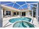 Relaxing screened lanai with pool and spa offers a perfect outdoor living and entertaining space at 2931 Bravura Lake Dr, Sarasota, FL 34240