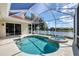 Relaxing screened lanai with pool and spa offers a perfect outdoor living space with scenic view at 2931 Bravura Lake Dr, Sarasota, FL 34240