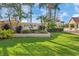 Community entrance sign 'Laurel Lakes' with lush landscaping, towering palms and blue sky at 2931 Bravura Lake Dr, Sarasota, FL 34240