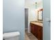 Well-appointed bathroom with wood vanity, granite counter, and stylish fixtures visible from entryway at 2961 Valencia Rd, Venice, FL 34293