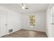 Comfortable bedroom with wood-look floors, white walls, and lots of natural light from two windows at 2961 Valencia Rd, Venice, FL 34293