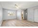 Spacious bedroom features wood-look floors, a ceiling fan, and plenty of natural light at 2961 Valencia Rd, Venice, FL 34293
