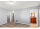 A well-lit bedroom featuring modern wood-look floors and easy access to the attached bathroom at 2961 Valencia Rd, Venice, FL 34293