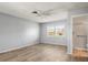 Bright bedroom with a ceiling fan, wood-look floors, and a window to let in natural light at 2961 Valencia Rd, Venice, FL 34293