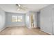 This bedroom boasts wood-look floors, a ceiling fan, and an adjacent bathroom at 2961 Valencia Rd, Venice, FL 34293