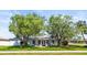 Lovely home with large trees and a well-manicured lawn at 2961 Valencia Rd, Venice, FL 34293