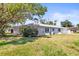 The side of this single-story home features blue shutters and well-maintained landscaping at 2961 Valencia Rd, Venice, FL 34293