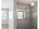 Hallway featuring a bright window, neutral paint, and modern flooring leading into adjacent rooms at 2961 Valencia Rd, Venice, FL 34293