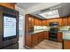 Well lit kitchen with stainless appliances and view into living area at 2961 Valencia Rd, Venice, FL 34293
