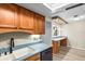 Cozy kitchen with wood cabinets, light counter tops, and a built in dining area with drop lighting at 2961 Valencia Rd, Venice, FL 34293