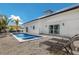 Backyard view features a refreshing pool, sun loungers for relaxation, lush landscaping, and a white-washed modern home at 305 73Rd St, Holmes Beach, FL 34217
