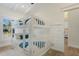 Bright bedroom featuring white bunk beds with blue accents and light-colored wood flooring at 305 73Rd St, Holmes Beach, FL 34217