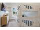 Bright bedroom featuring white bunk beds with blue accents and light-colored wood flooring at 305 73Rd St, Holmes Beach, FL 34217