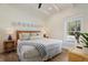 Well-lit bedroom with white and blue decor, wood furniture, and a bright window at 305 73Rd St, Holmes Beach, FL 34217