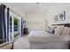 The bedroom features access to a private pool area and neutral decor at 305 73Rd St, Holmes Beach, FL 34217
