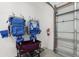 Garage space with storage solutions, including folding chairs and a wagon, and a white sectional garage door at 305 73Rd St, Holmes Beach, FL 34217