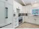 Bright kitchen features stainless steel appliances, white cabinetry, and modern fixtures at 305 73Rd St, Holmes Beach, FL 34217